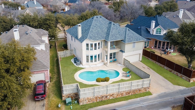 view of pool featuring central AC, a residential view, a patio, and a fenced backyard