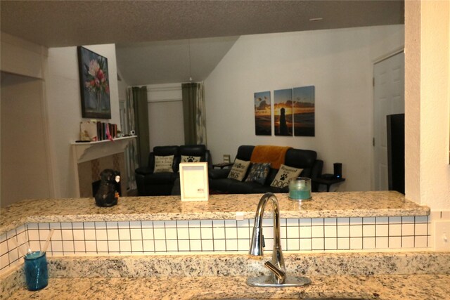 kitchen featuring light stone countertops and sink