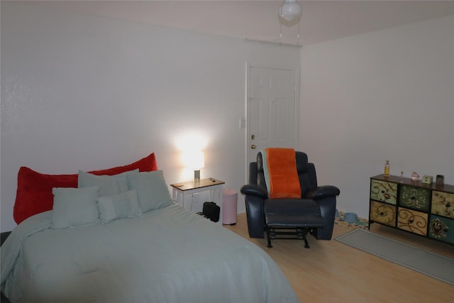 bedroom with ceiling fan and hardwood / wood-style floors