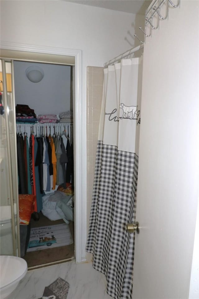 bathroom featuring toilet and a shower with shower curtain