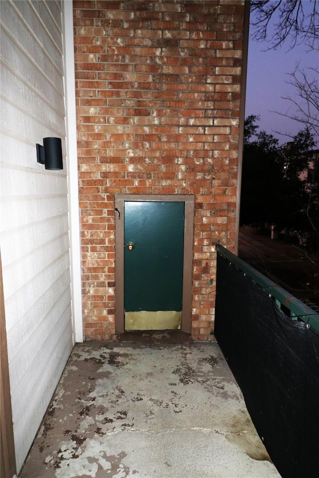 view of exterior entry at dusk