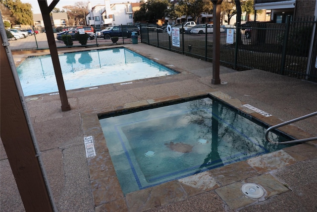 view of pool with a community hot tub and a patio