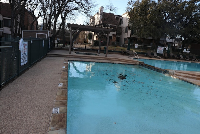 view of swimming pool with a pergola