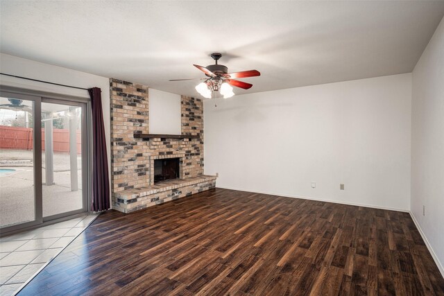 empty room with ceiling fan, dark hardwood / wood-style floors, lofted ceiling, and a healthy amount of sunlight