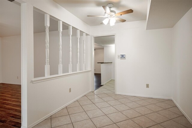 kitchen with ceiling fan, light tile patterned floors, double oven, and sink