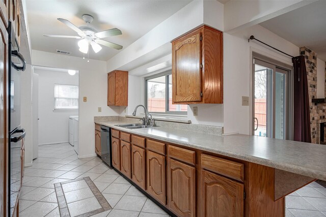 kitchen featuring ceiling fan, sink, light tile patterned floors, and black appliances