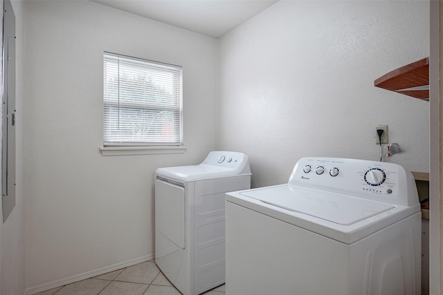 laundry room featuring light tile patterned floors, laundry area, separate washer and dryer, and baseboards