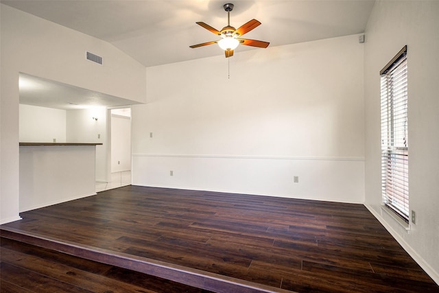 kitchen with light tile patterned floors, a sink, visible vents, brown cabinets, and dark countertops