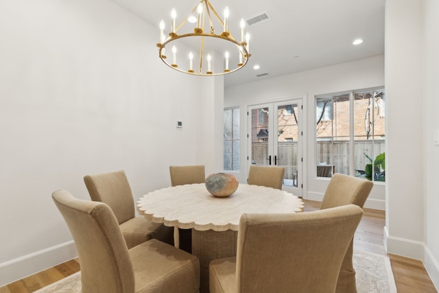 dining room with a chandelier and light hardwood / wood-style flooring