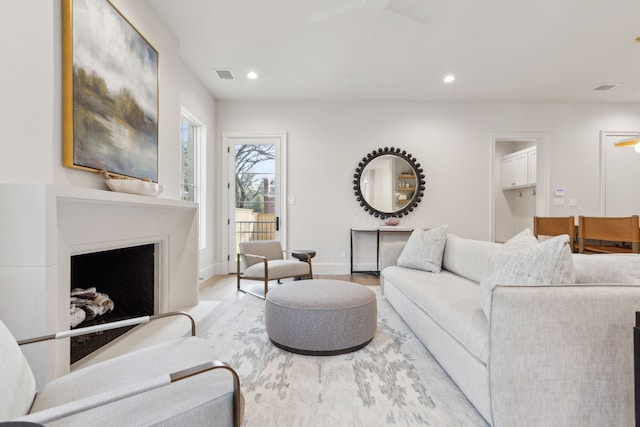 living room with ceiling fan and light hardwood / wood-style floors