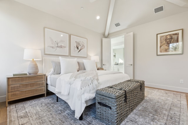 bedroom with hardwood / wood-style floors, ensuite bathroom, and lofted ceiling with beams