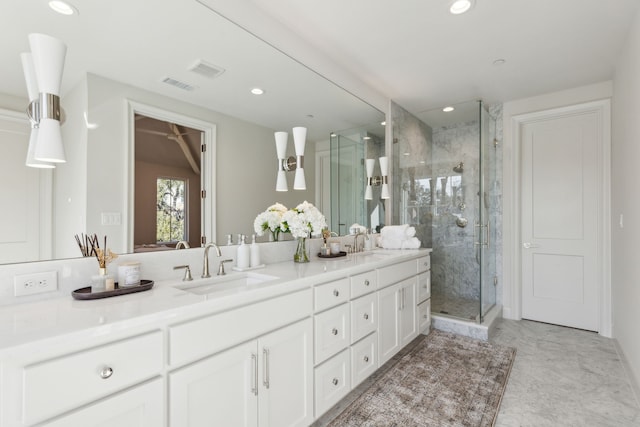 bathroom featuring an enclosed shower and vanity