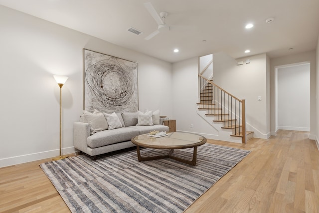 living room featuring ceiling fan and light hardwood / wood-style flooring