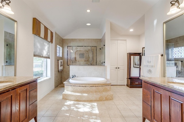 bathroom with vaulted ceiling, vanity, separate shower and tub, and tile patterned flooring