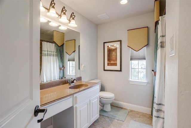 bathroom featuring toilet and vanity