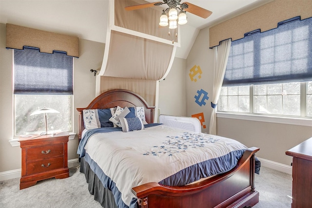 carpeted bedroom featuring vaulted ceiling and ceiling fan