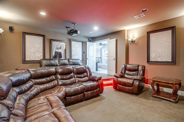 home theater room with light carpet and ceiling fan