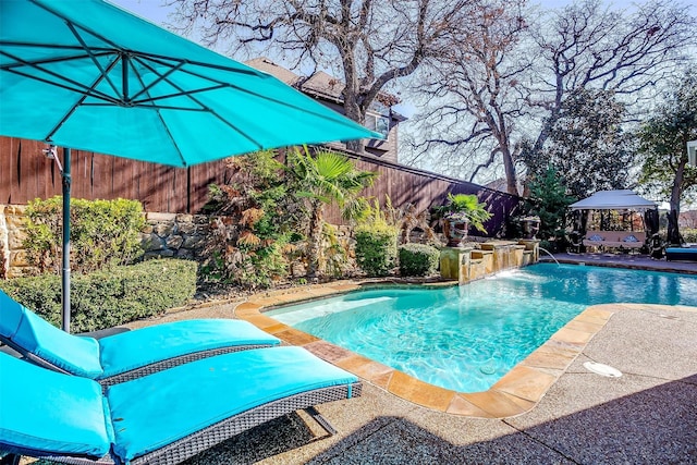 view of pool featuring a gazebo and pool water feature