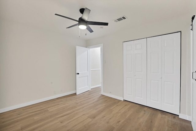 unfurnished bedroom featuring ceiling fan, a closet, and light hardwood / wood-style floors