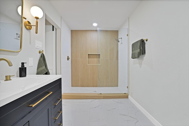 bathroom featuring tiled shower and vanity