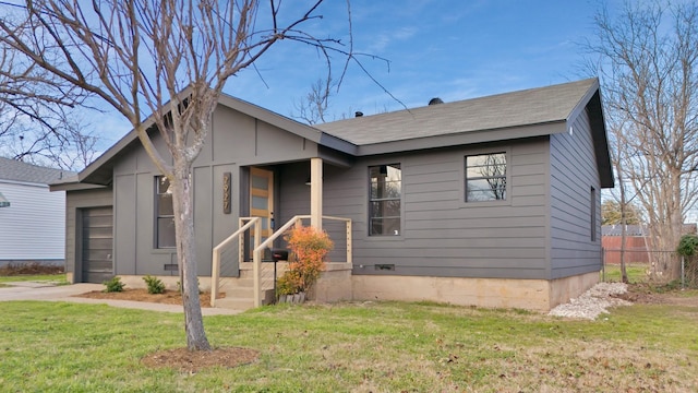 bungalow-style home with a front yard