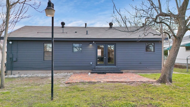 back of house featuring a patio area, a lawn, and french doors