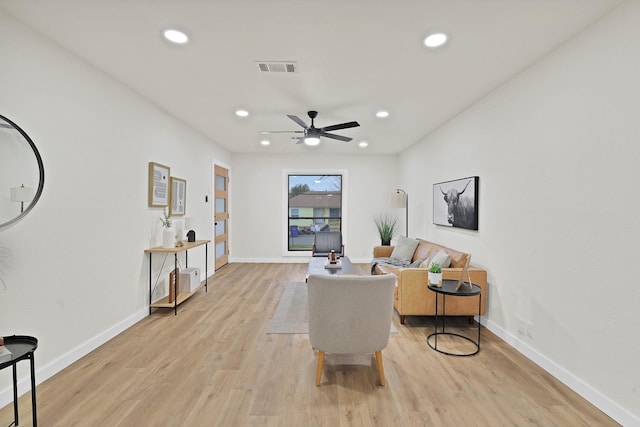 sitting room with ceiling fan and light hardwood / wood-style flooring