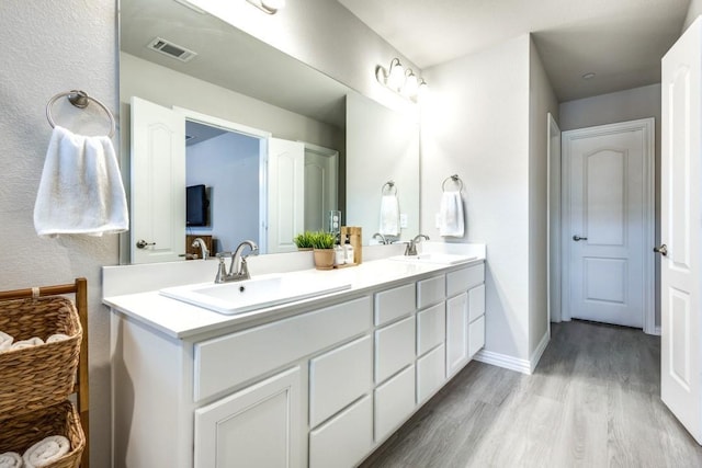 bathroom with hardwood / wood-style flooring and vanity