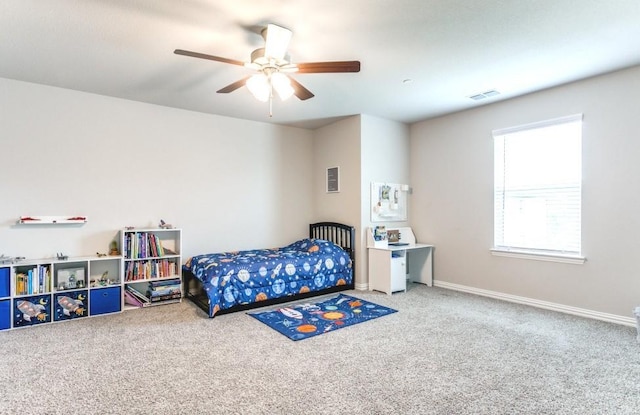 bedroom featuring ceiling fan and carpet