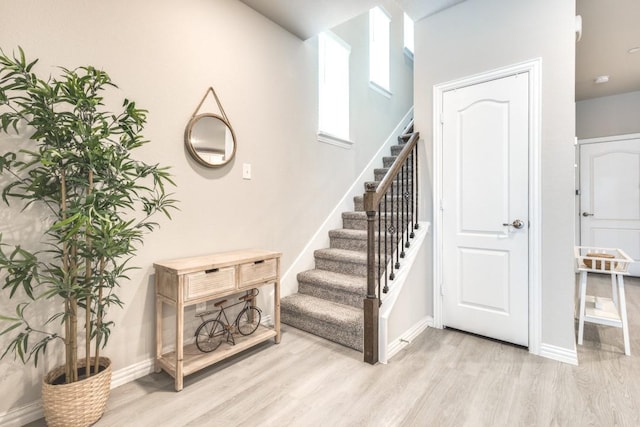 stairs with hardwood / wood-style flooring