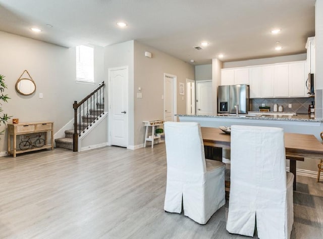 dining area with light hardwood / wood-style flooring