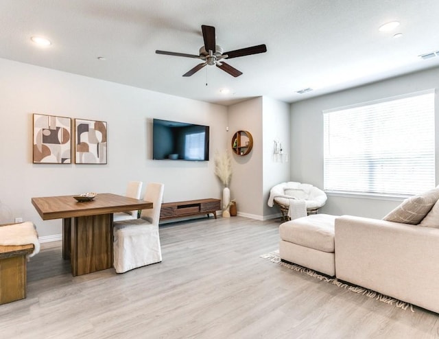 living room featuring hardwood / wood-style flooring and ceiling fan