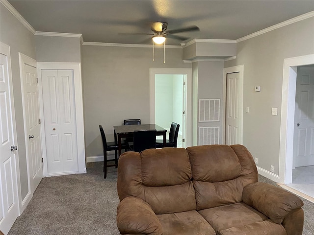 carpeted living room with ceiling fan and ornamental molding