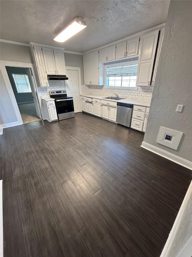 kitchen featuring white cabinets, appliances with stainless steel finishes, sink, and tasteful backsplash