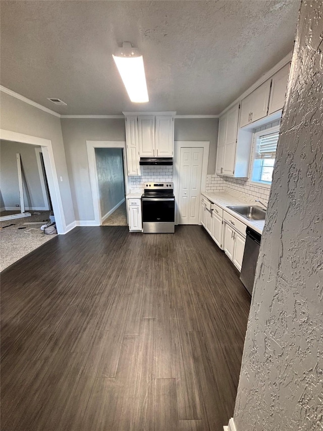 kitchen with backsplash, appliances with stainless steel finishes, crown molding, and white cabinetry