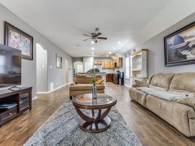 living room with dark wood-type flooring and ceiling fan