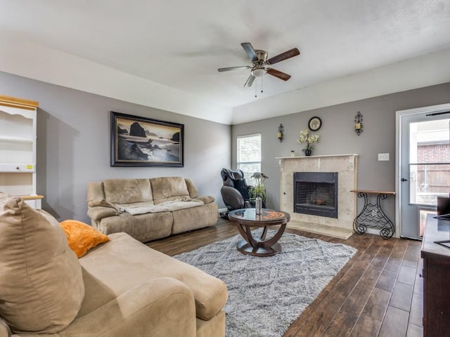 living room featuring ceiling fan and a premium fireplace