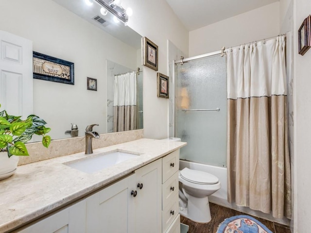 full bathroom with toilet, hardwood / wood-style flooring, vanity, and shower / bath combination with glass door