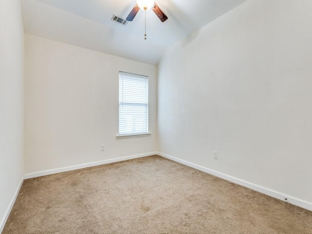 spare room with vaulted ceiling, ceiling fan, and carpet floors