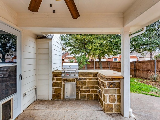 view of patio / terrace with exterior kitchen, grilling area, and ceiling fan