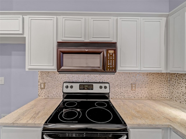 kitchen with decorative backsplash, white cabinetry, and stainless steel range with electric stovetop