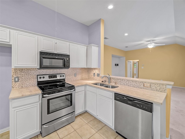 kitchen with white cabinets, appliances with stainless steel finishes, sink, kitchen peninsula, and light tile patterned floors