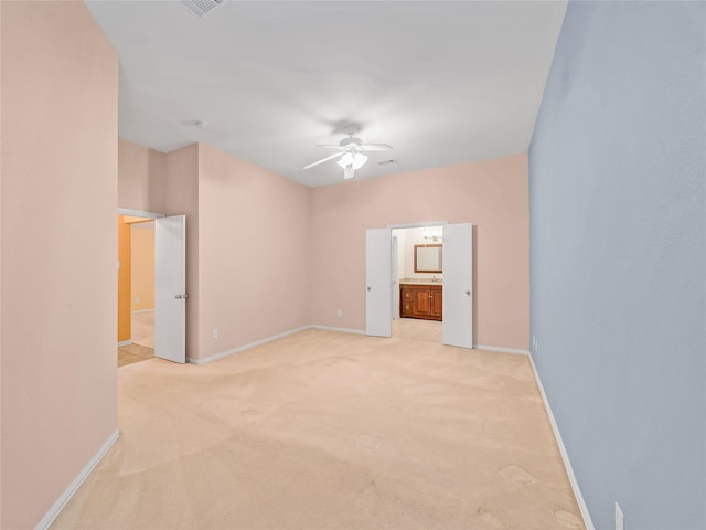 carpeted empty room featuring ceiling fan