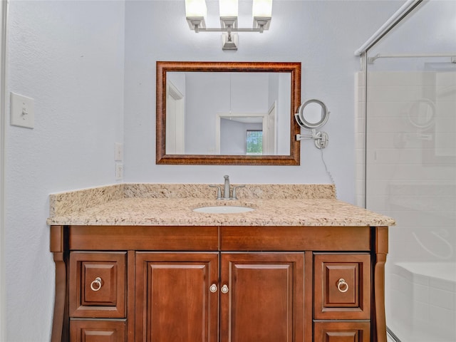 bathroom featuring an enclosed shower and vanity