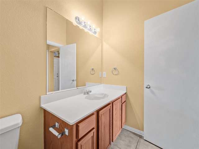 bathroom featuring tile patterned floors, vanity, and toilet