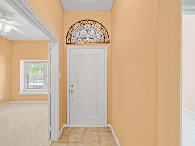 tiled foyer entrance featuring ceiling fan