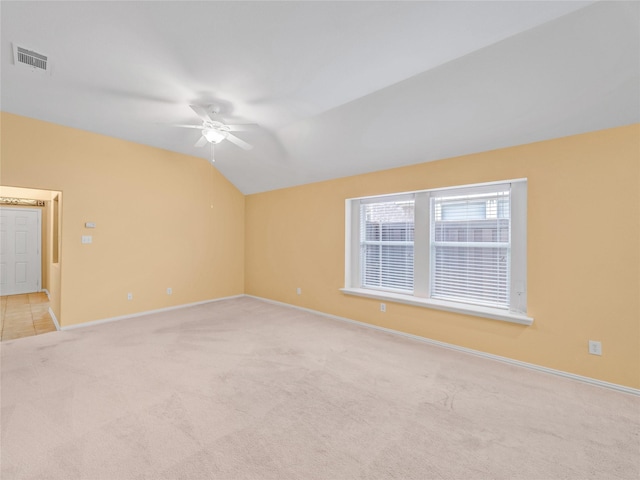 carpeted empty room with ceiling fan and vaulted ceiling