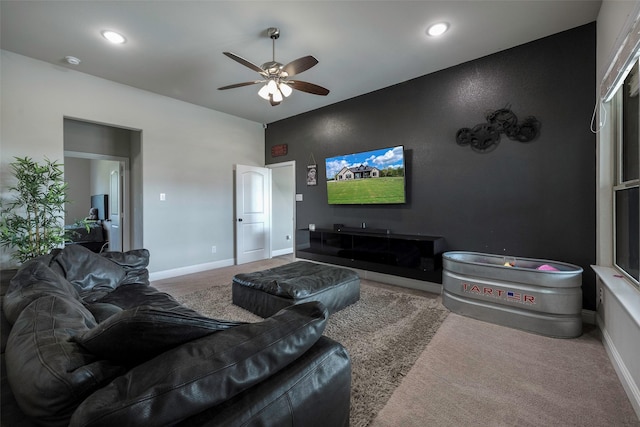 living room featuring ceiling fan and carpet