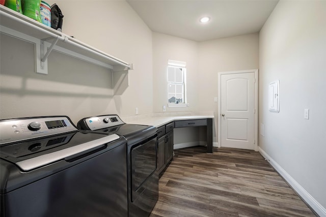 washroom with dark hardwood / wood-style floors, washer and dryer, and cabinets