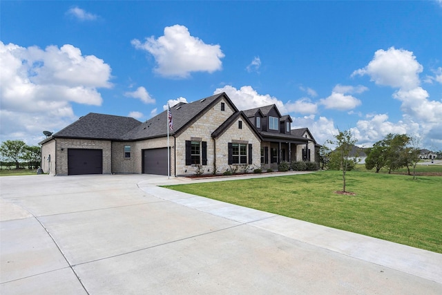 french country home with a front lawn and a garage